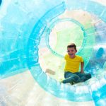 Child in an inflatable zorbing bubble