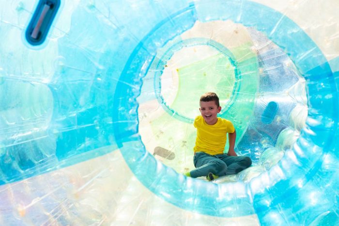 Cute,Little,Boy,Having,Fun,In,Zorb,Cylinder,On,Water