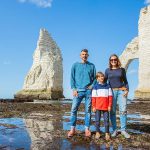 Family standing on the beach in Etretat, Normandy